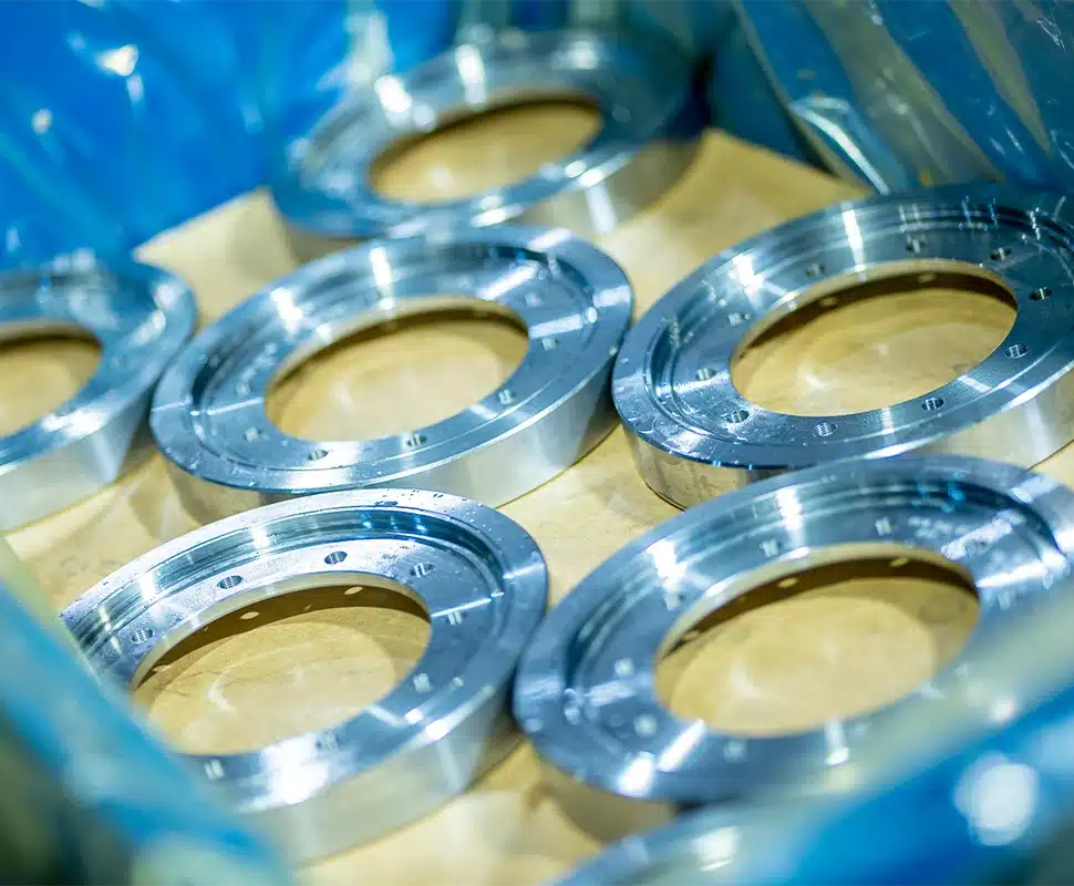 Page-Process-MACHINING-13-1 Series of machined crown gears, turned and bored, on a conveyor.